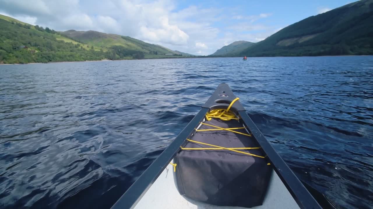 Wonderful Nature Adventure On A Boat Ride Over The Calm Blue Caledonian Canal In Scotland With Lush Hills Scenery Under The Blue Sky - Wide Shot