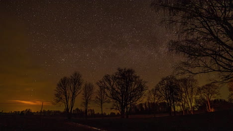 Timelapse-of-an-evening-sky-as-stars-are-moving-throughout-the-night-sky-as-few-clouds-pass-through-the-sky