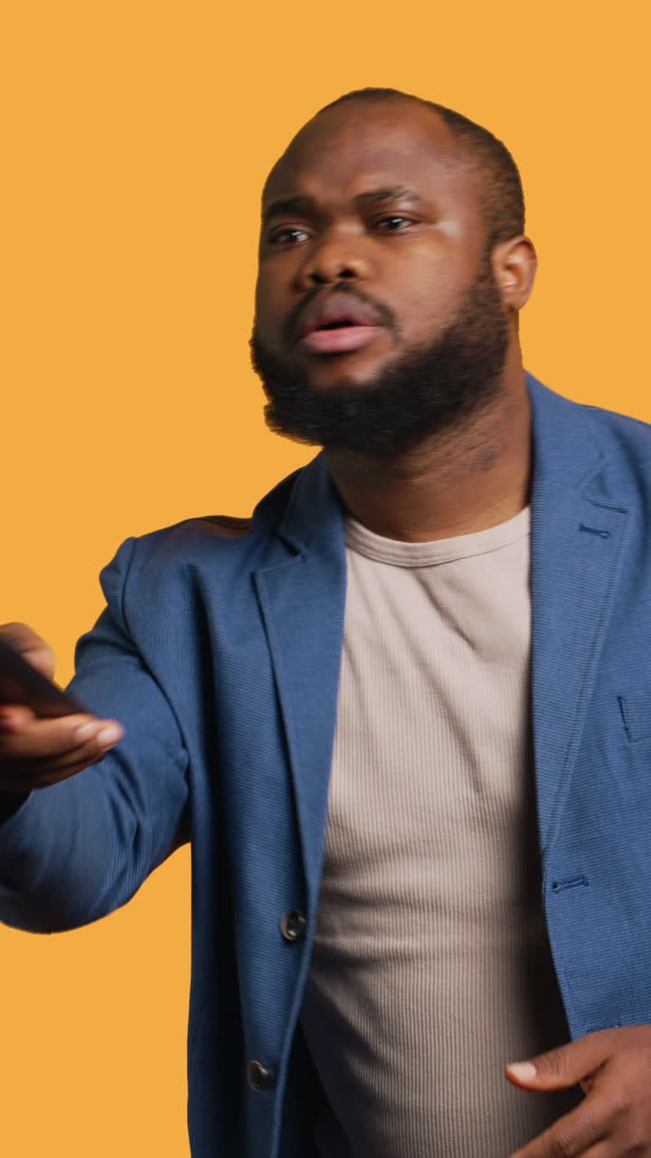 Vertical video Man watching sports match on TV, engrossed by jaw dropping action