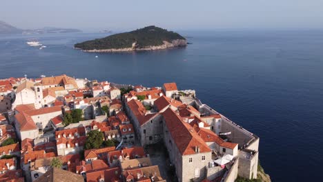 tourists sightseeing fortified city walls and medieval houses of dubrovnik