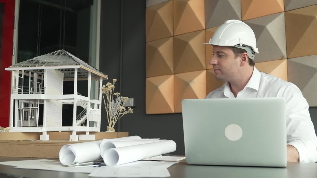 Professional engineer using laptop analysis house construction. Manipulator.