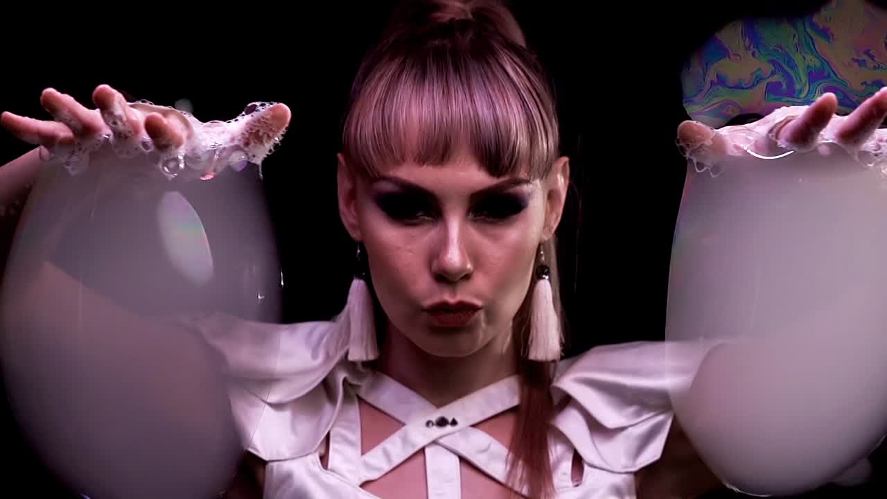 cu 슬로우모션 비눗방울 트릭 그 소녀는 연기와 함께 큰 거품으로 저글링을 합니다