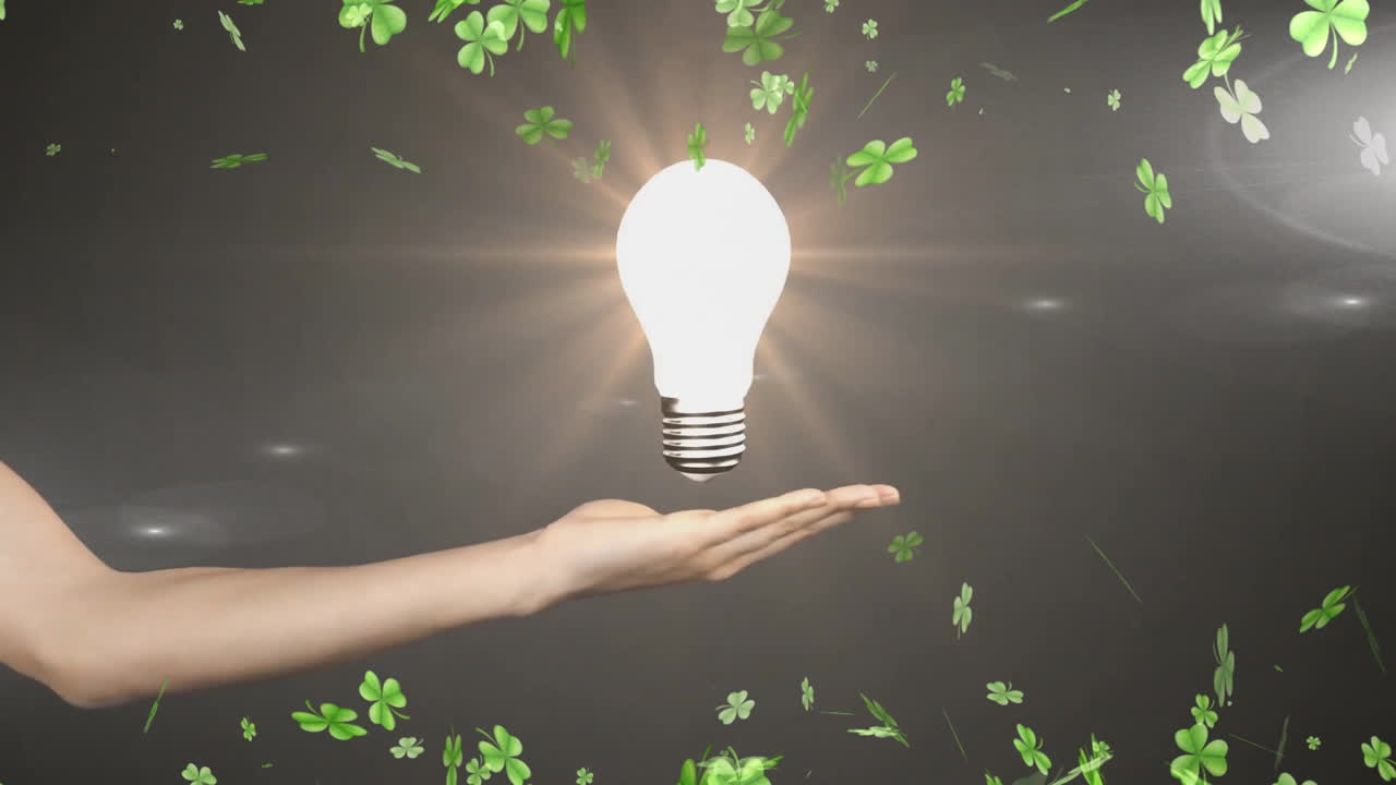 Holding glowing light bulb, hand surrounded by floating green clovers in animation