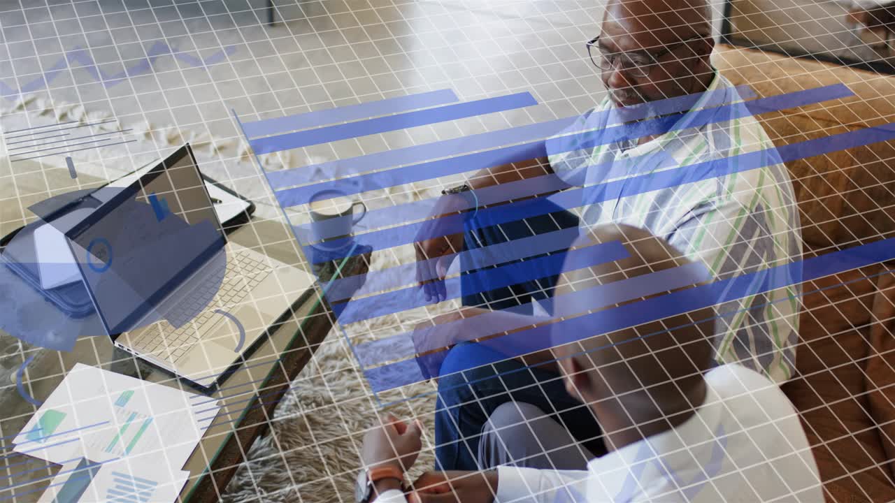 Adult pointing at laptop, senior listening, finance charts appearing over table for review