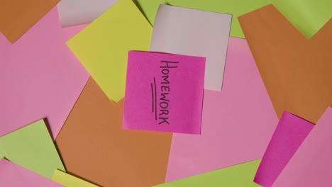 education concept of revolving sticky notes with homework written on top note