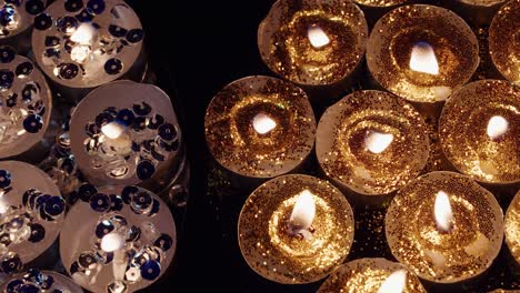 Background-of-tea-cup-many-glitter-size-Candles-Lights-shines-yellow-gold-bright-for-celebration,-religion,-anniversary-Festival
