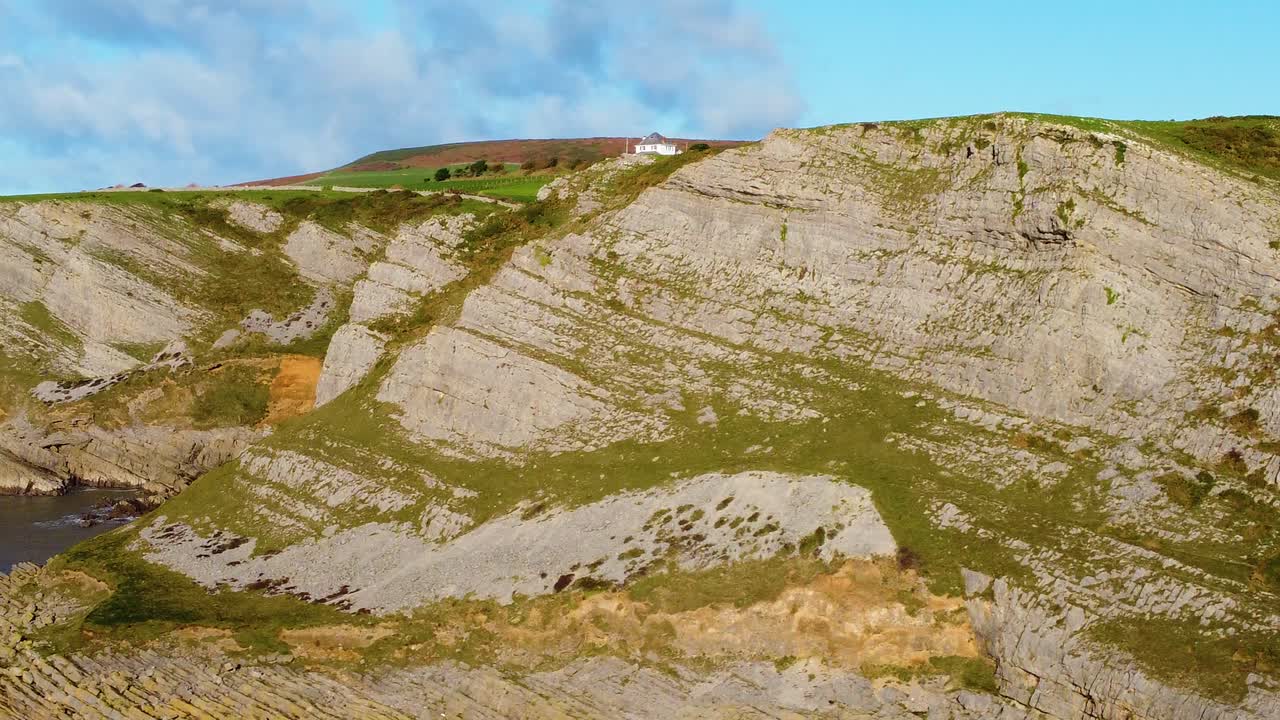 Dramatic Coastline with Slanted Rock Formation as Drone Moves Sideways. Gower Coast in South Wales, UK