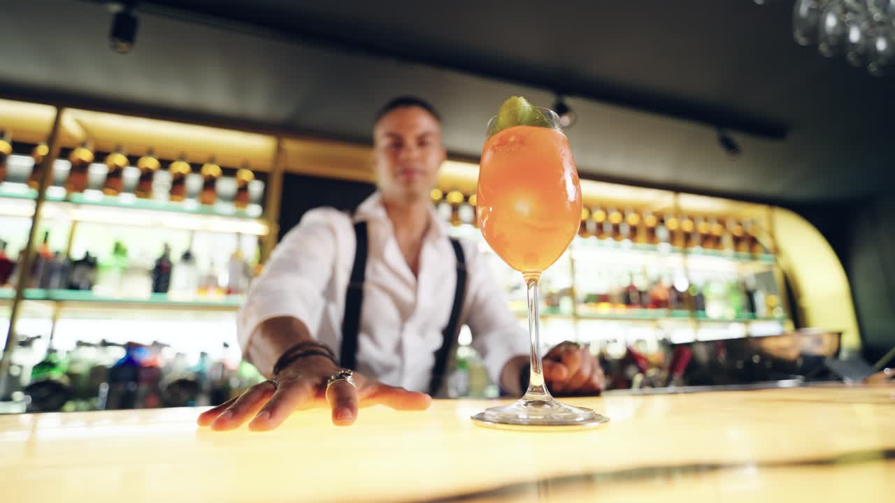 Professionele bartender presenteert een heerlijke cocktail in een moderne bar