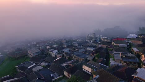 sunrise above the clouds on village housing and fog in the morning