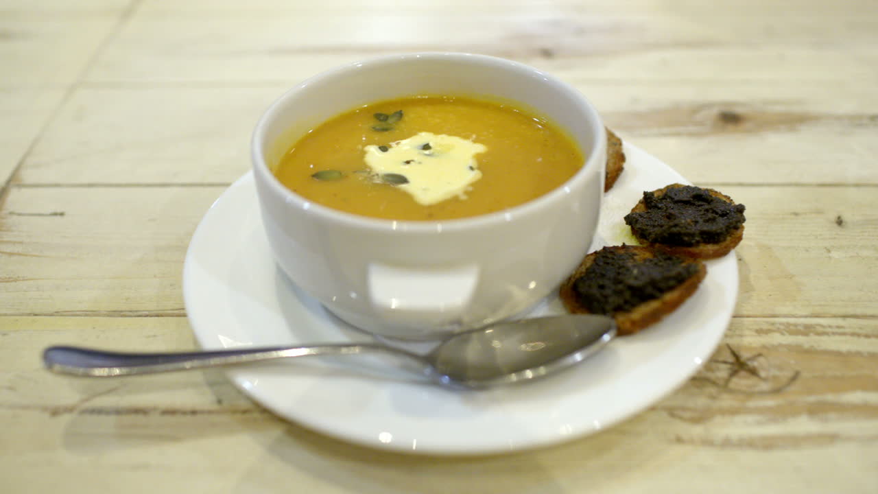 Serving of soup with bruschetta in cafe or restaurant