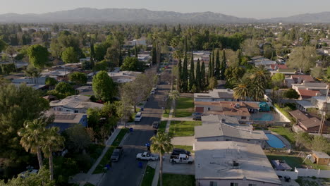 from a height, you can see los angeles with its neighborhoods, which have many streets and roads, as well as many trees on the sidewalks