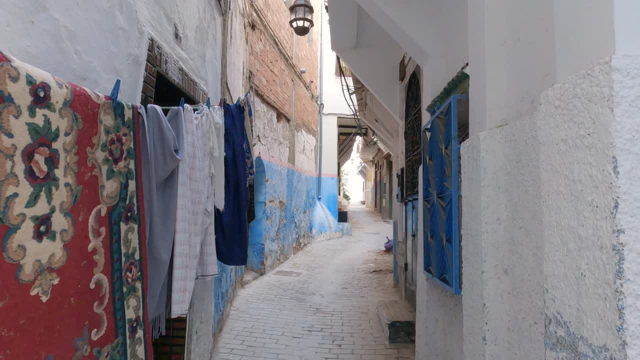 Tangier, Morocco: Quaint alley in Medina with hanging laundry and aged doors