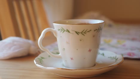 elegant white teacup and saucer with floral design
