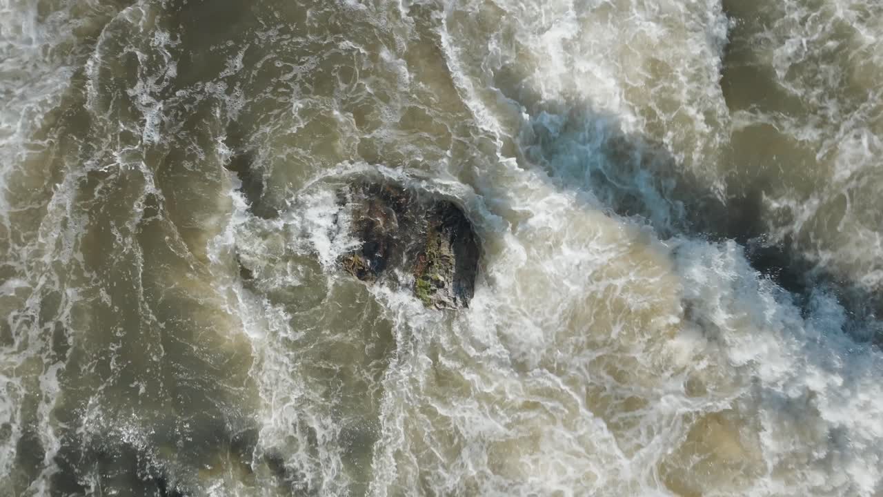 Turbulent waters cascading over rocks at owen sound waterfall in canada, aerial view