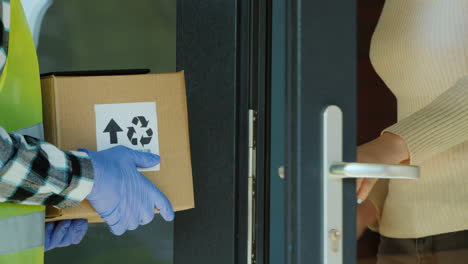 courier passes parcel to the recipient delivery of goods to the house