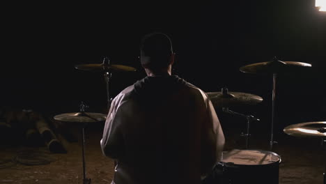 drummer in a dark studio