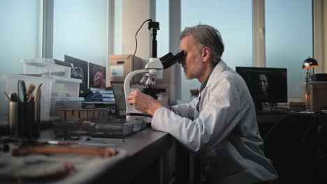 scientist using microscope in a lab