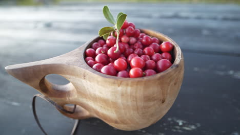 fresh lingonberries in wooden bowl. close-up