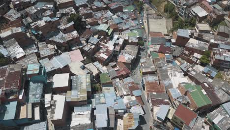 drone aerial flying low over comuna 13 slums famous area in medellin, colombia