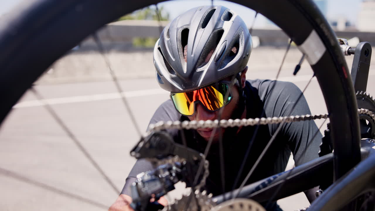 Cyclist Adjusting Bicycle Chain and Gears on the Road
