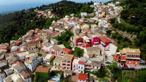 Aerial-drone-shot-over-old-Greek-mountain-village-of-Lakones-in-Corfu-surrounded-in-green-lush-vegetation