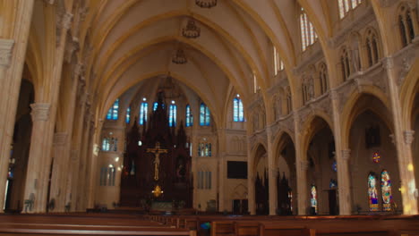 inside the large church, there was a woman walking up the altar