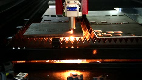 industrial laser cut machine while cutting the sheet metal with the sparking light.