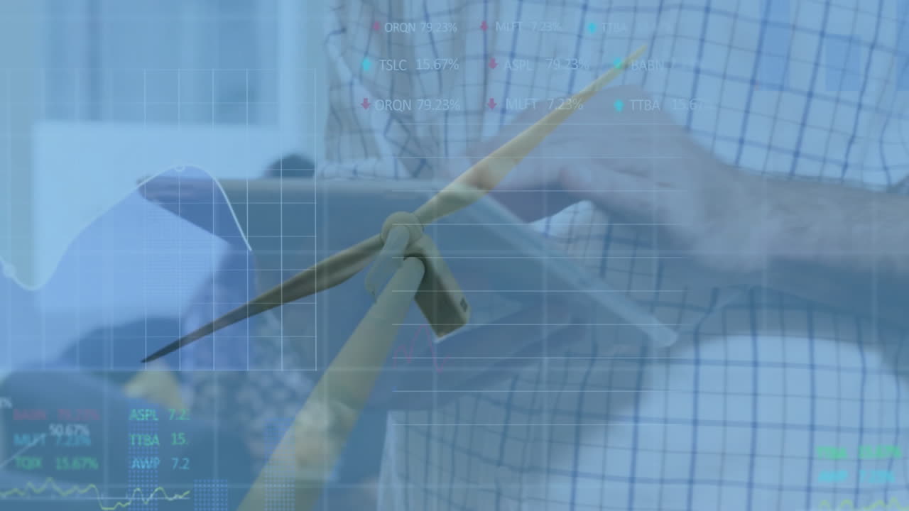 Engineer presenting tablet data in tech office, overlaying wind turbine model with animated graphs