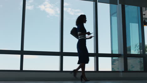 business woman using smartphone walking through office texting sending messages successful female executive checking emails on mobile phone arriving at workplace