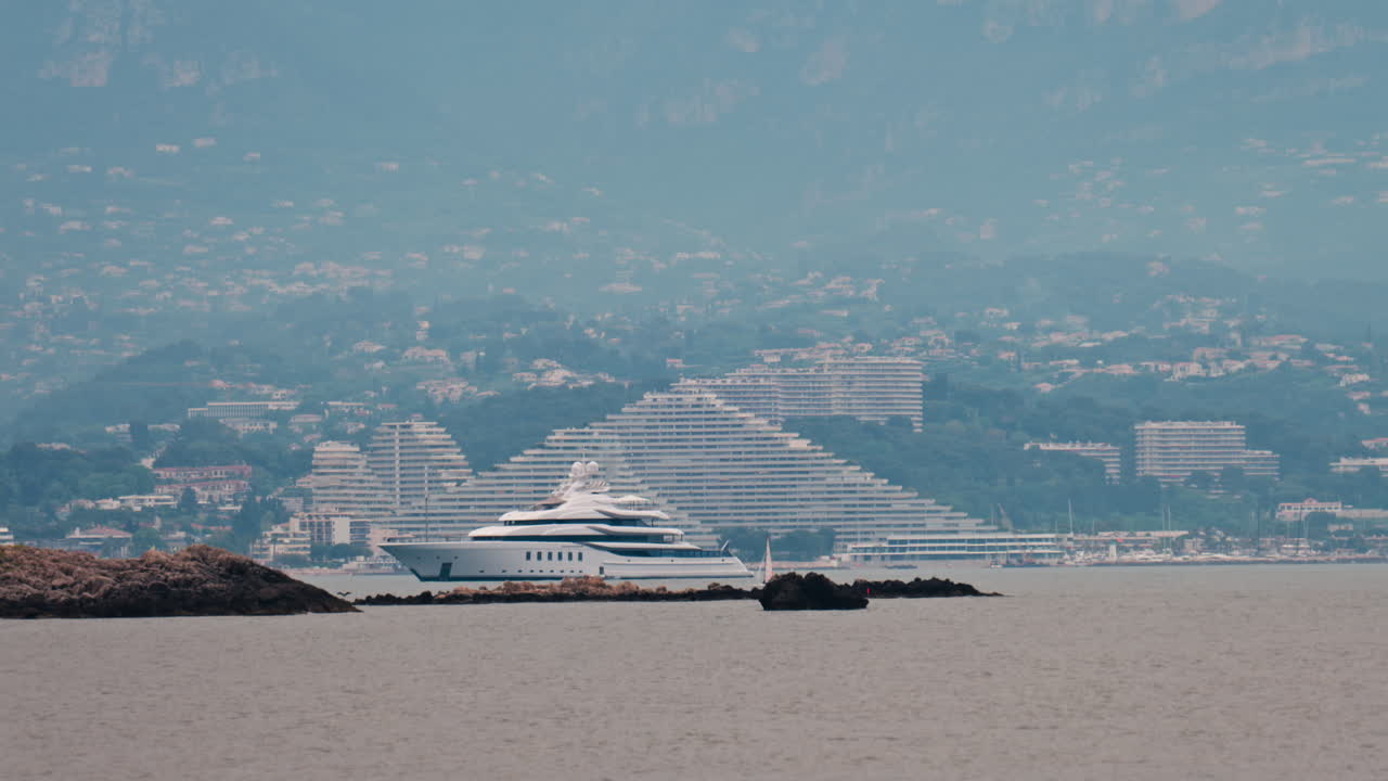 Distant view of a yacht docked near the Marina Baie des Anges in Villeneuve-Loubet, France