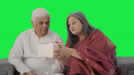 Cute-Old-Indian-wife-giving-a-gift-to-her-husband-Green-screen