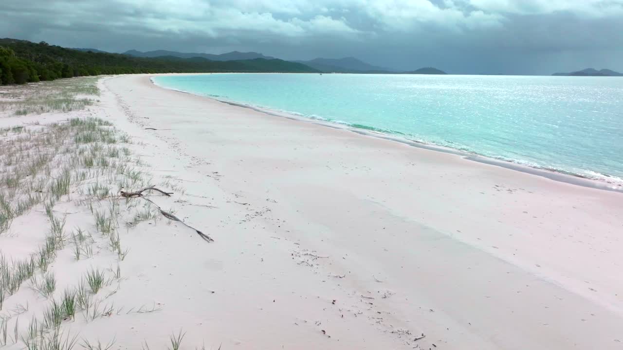 Whitehaven Beach aerial drone Whitsundays Island Australia cloudy shade rain sunny sun stunning white sand outer Great Barrier Reef clear blue aqua ocean Hill Inlet Lookout tourist boat forward pan up