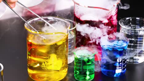 beakers with colorful liquids and visible reactions