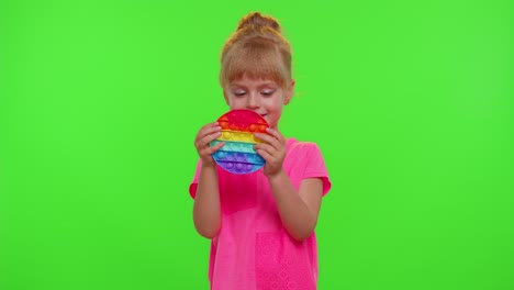 Child-girl-kid-playing-squeezing-anti-stress-pop-it-touch-screen-toys-simple-dimple-game,-chroma-key