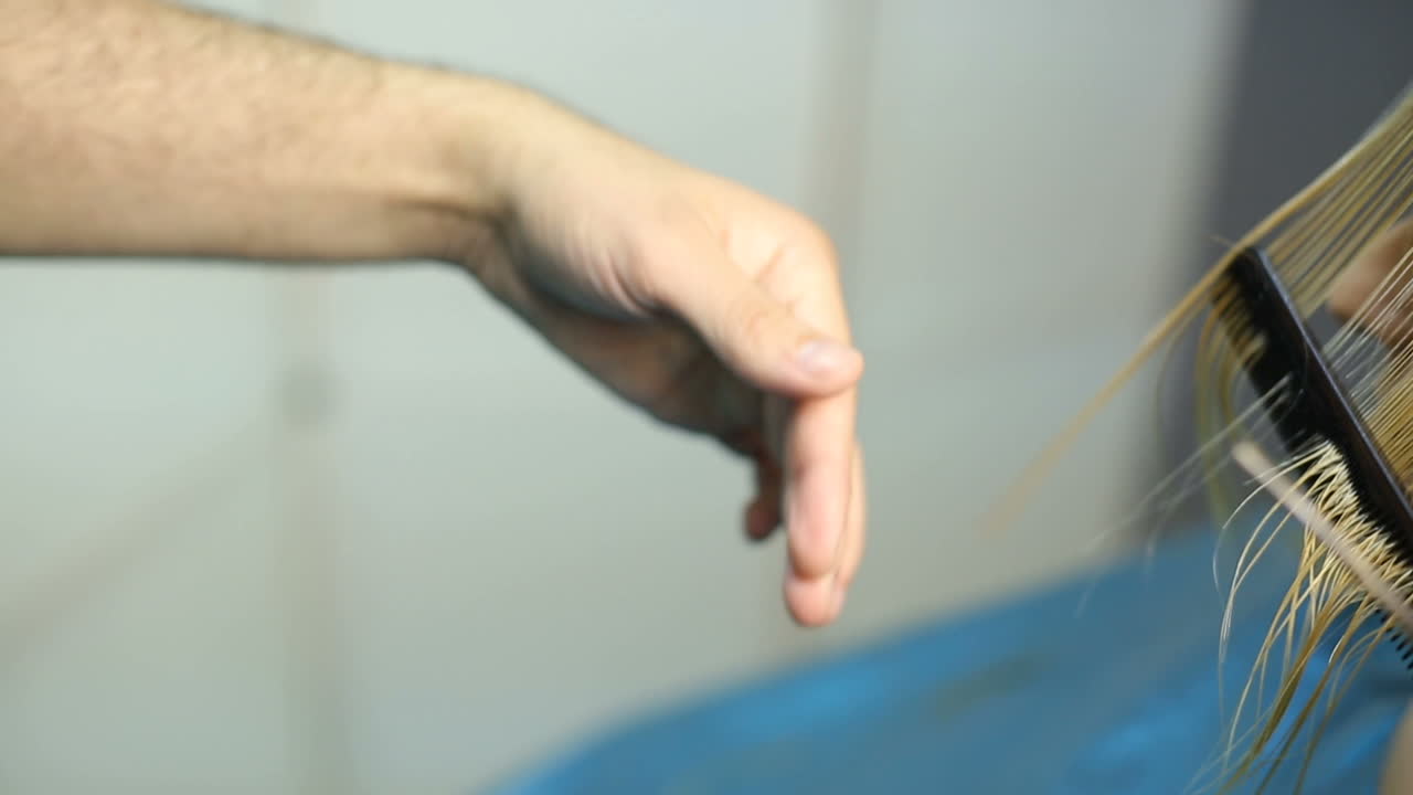 Stylist dying hair. Professional hairdresser dyeing hair of her client at beaty salon