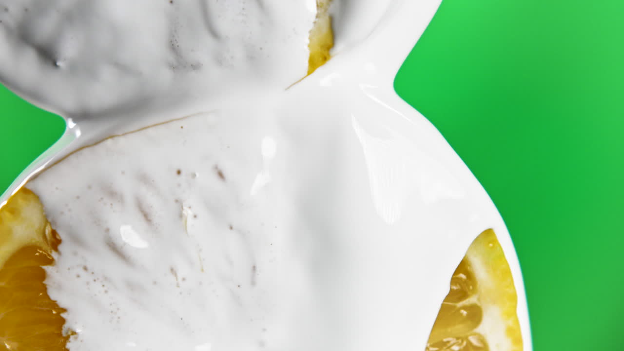 White Liquid Pouring Over Lemon Slices