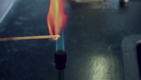 Close-up-of-blue-bunsen-burner-flame-followed-by-calcium-flame-test-burning-orange