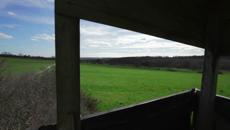 skyline and green fields landscape timelapse from hunting watchtower window pov