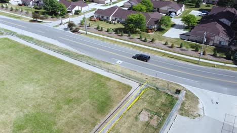 a drone tracking shot of suburban traffic.