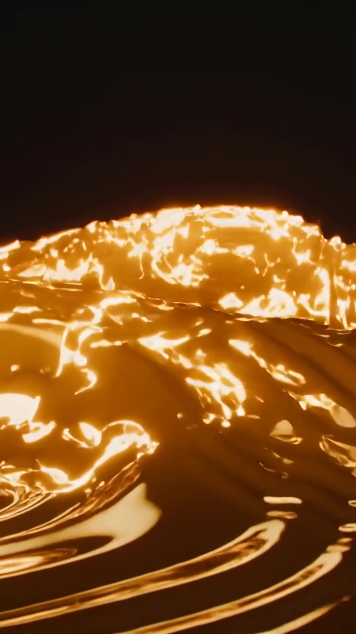 Vidéo verticale : Crête montante provoquant la formation d'ondulations circulaires sur une surface dorée dans le noir avec des reflets.