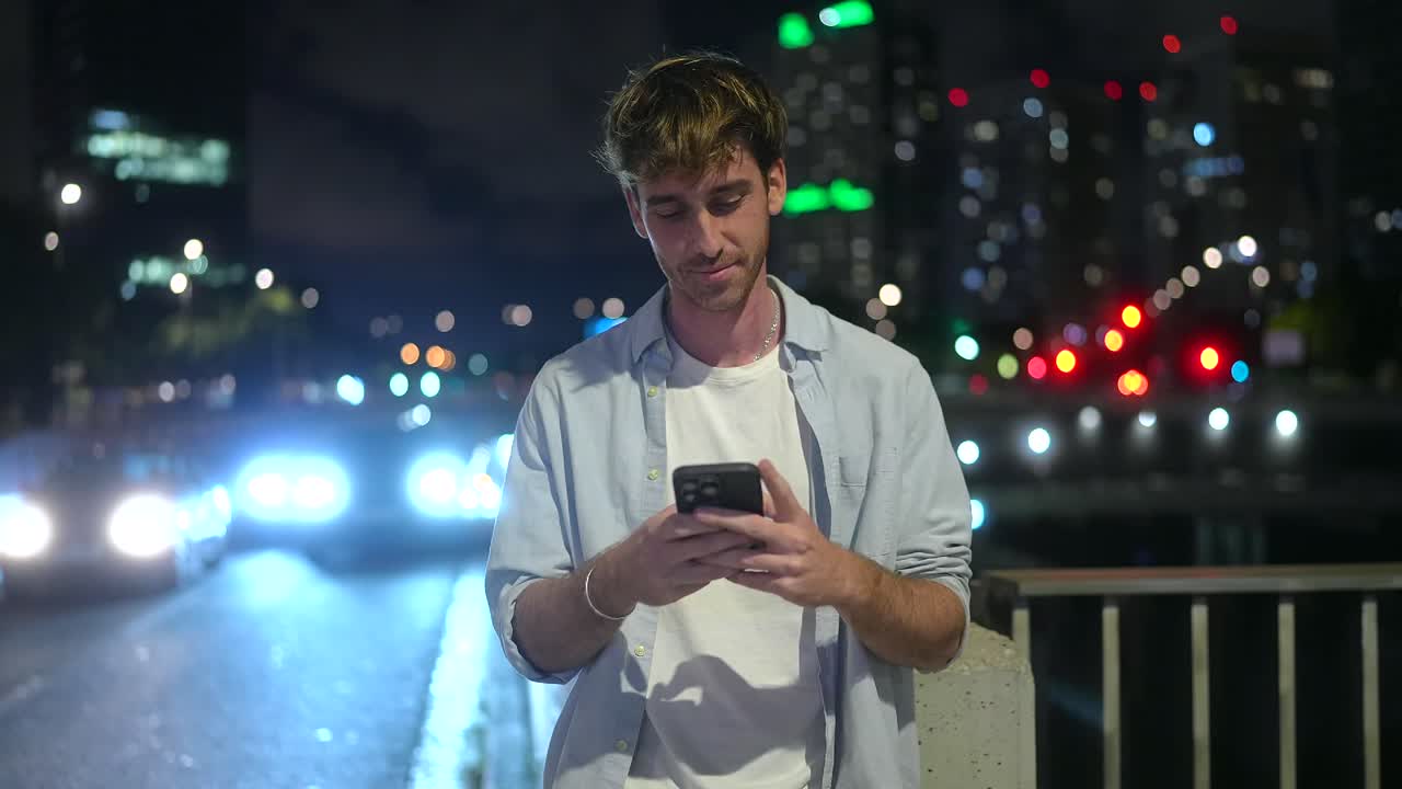 Man Using Smartphone in Urban Night City