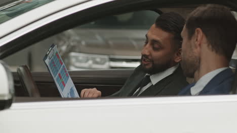 diverse colleagues working in car