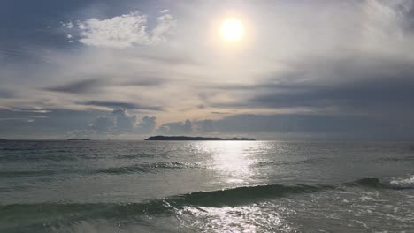 Static-wide-angle-shot-of-small-waves-in-the-ocean-on-a-sunny-day