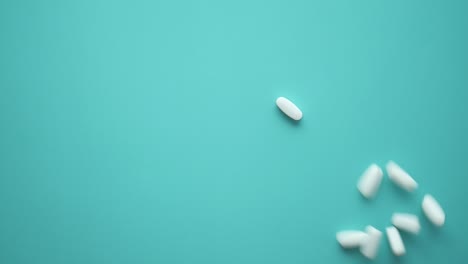 white pills on light blue background