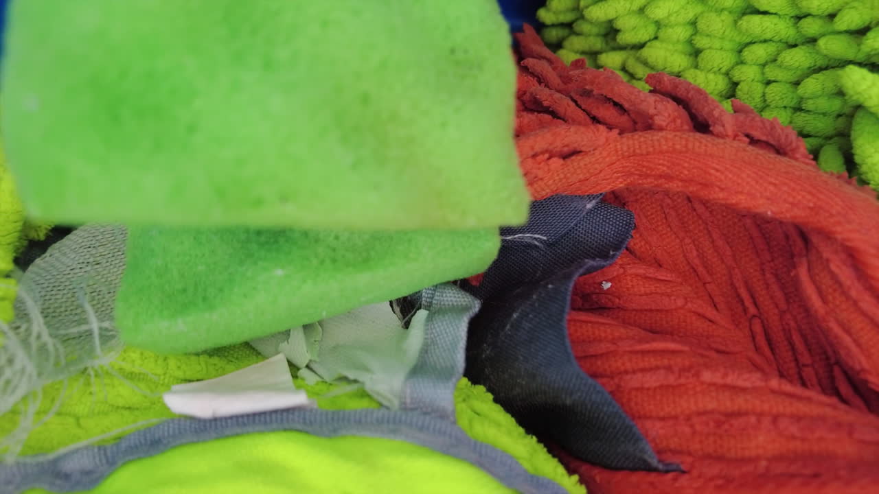 Different cleaning supplies in a blue bucket