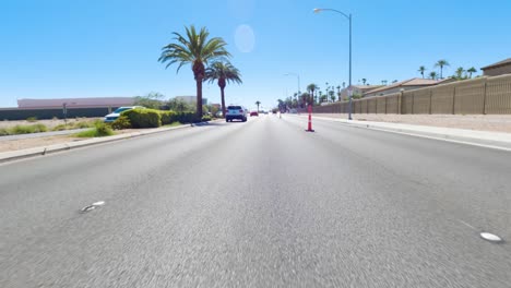 car pov driving down the street on a bright sunny day in nevada