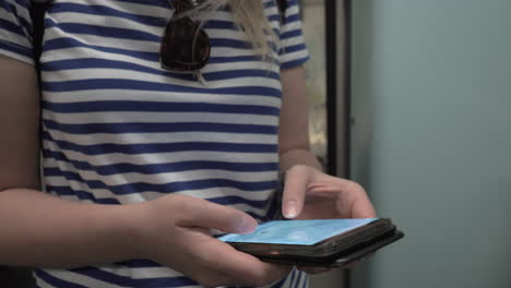 mujer mirando el mapa en el teléfono celular durante un viaje en el metro