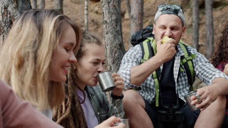 friends enjoying a picnic in the woods