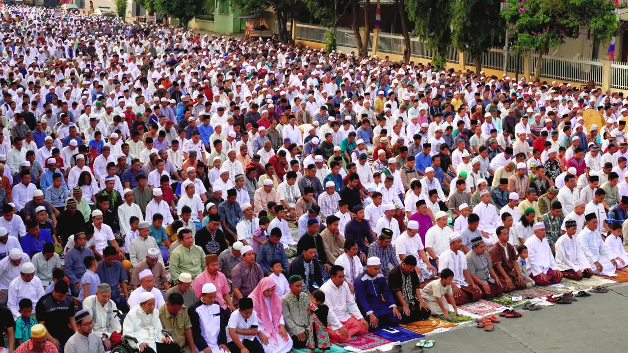 Indonesian muslims pray together on the road