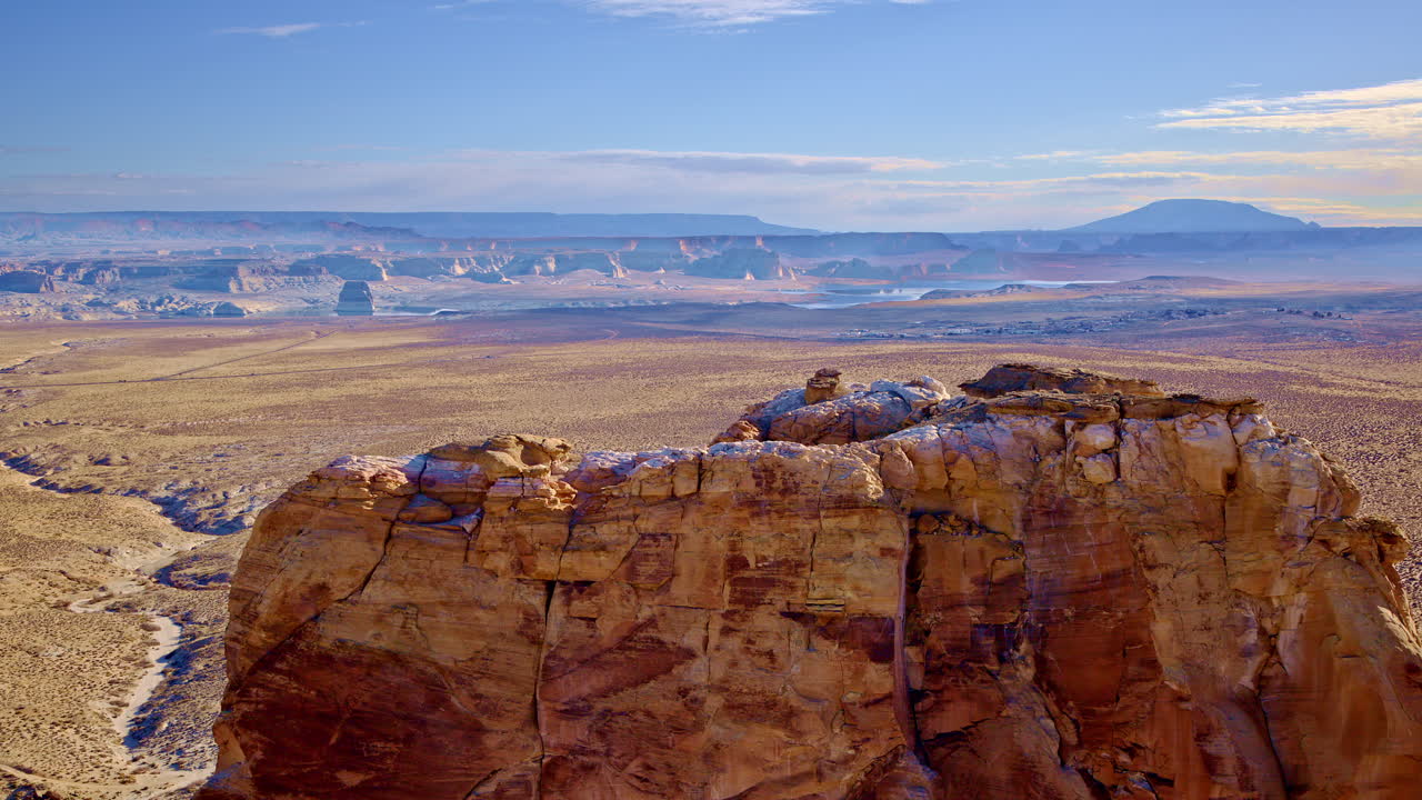 Dramatic drone shot clearing large rock to reveal amazing red rock canyon landscape